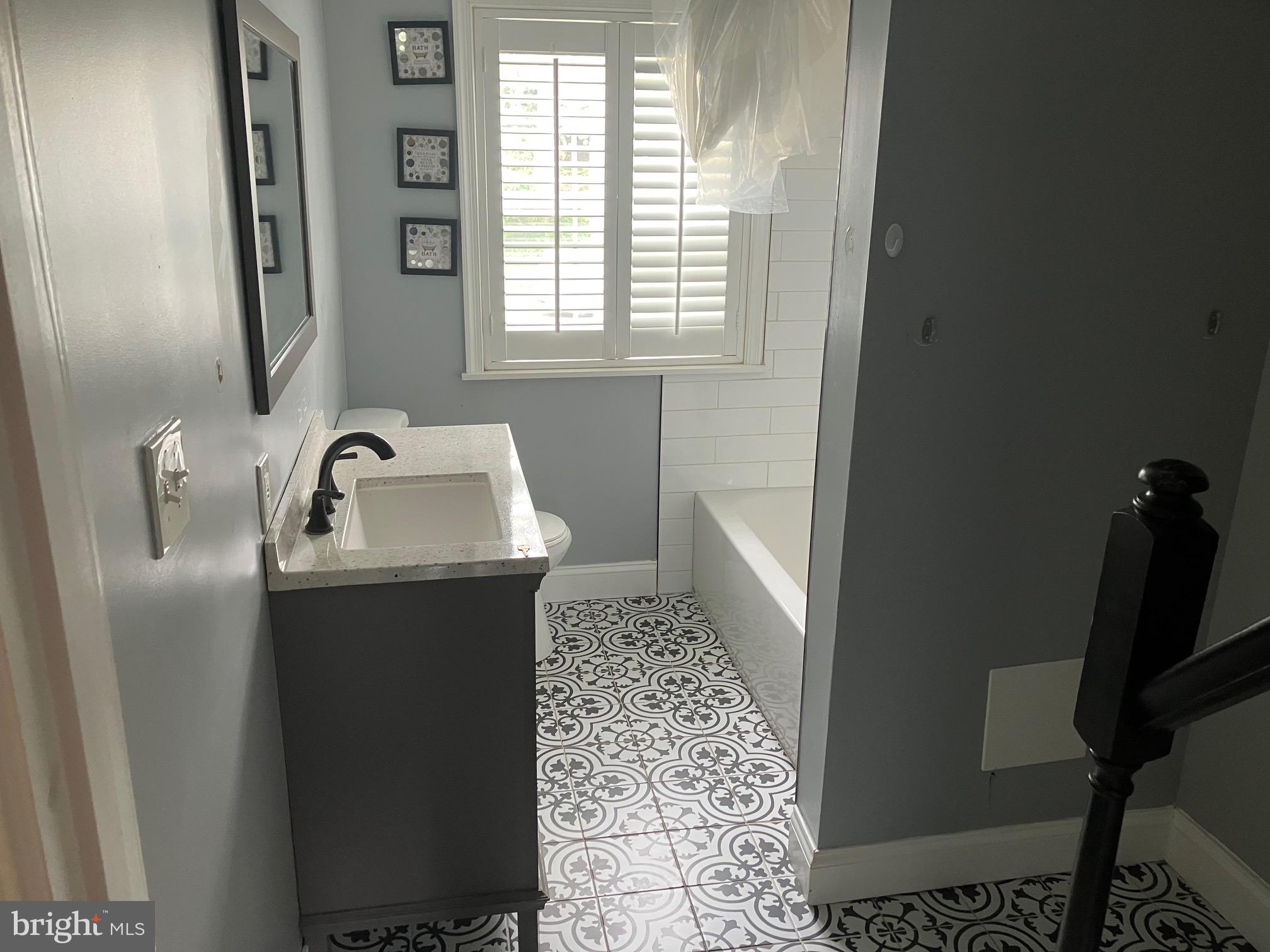 4008 Deepwood Road Baltimore, MD 21218 - Photo 16 of 18 a bathroom with a sink and mirror