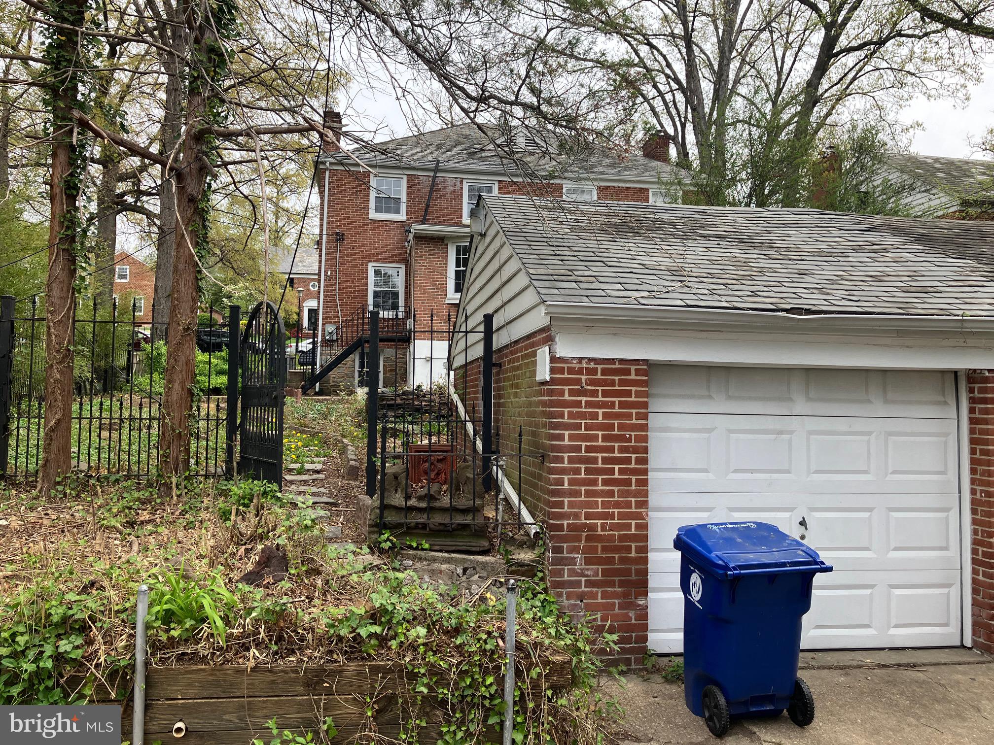 4008 Deepwood Road Baltimore, MD 21218 - Photo 17 of 18 a view of a house with a bench in the forest