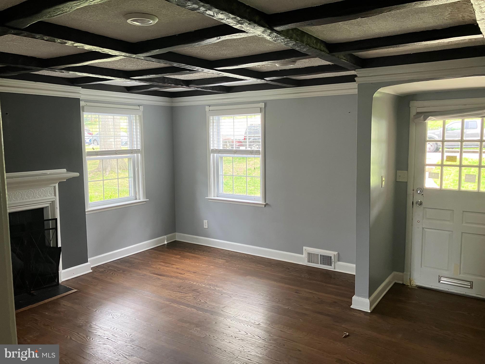 4008 Deepwood Road Baltimore, MD 21218 - Photo 2 of 18 a view of an empty room with wooden floor and a window