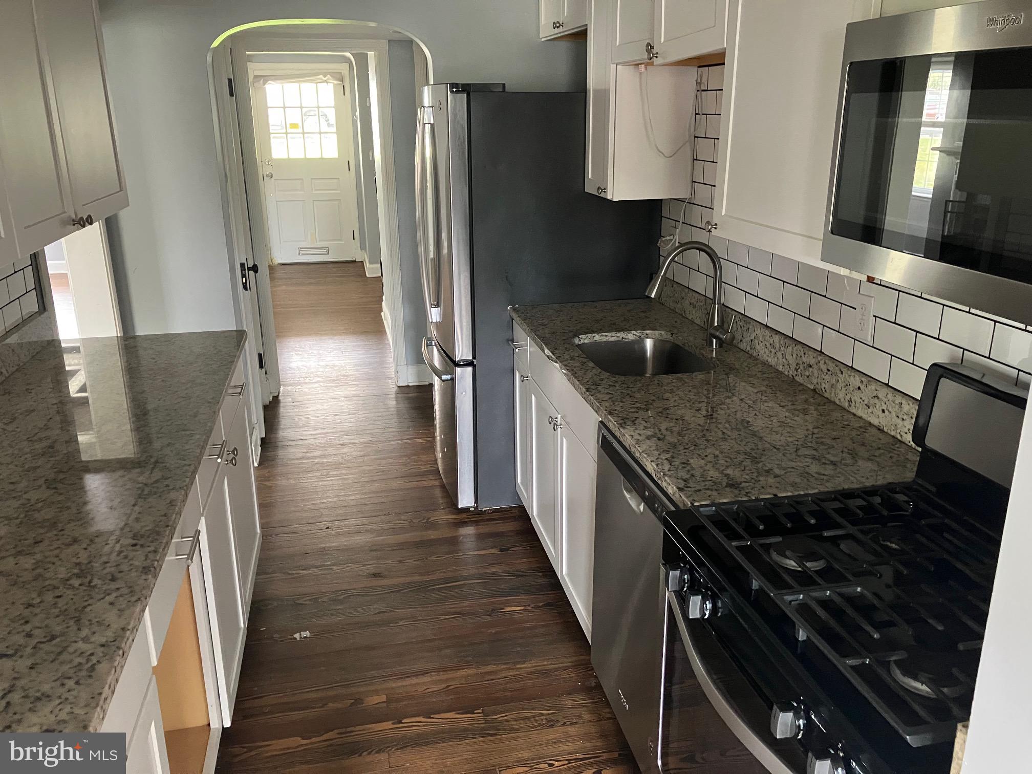 4008 Deepwood Road Baltimore, MD 21218 - Photo 5 of 18 a kitchen with granite countertop a sink stove and refrigerator