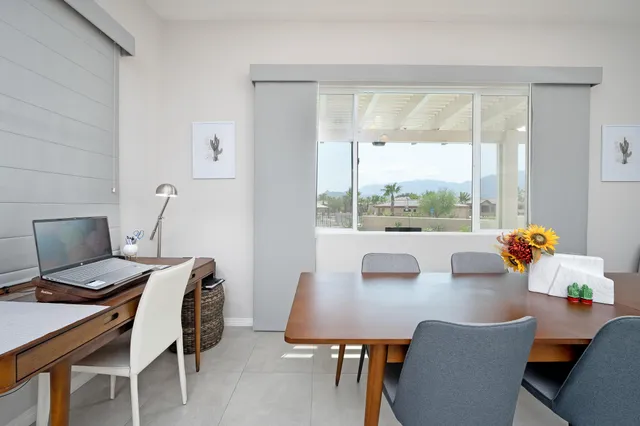 a view of a dining room with a table and chairs