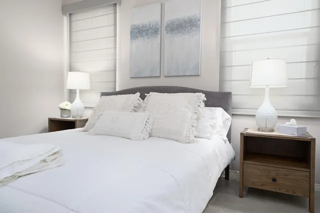a large white bed in a white room
