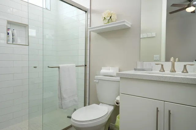 a bathroom with a sink a toilet and shower