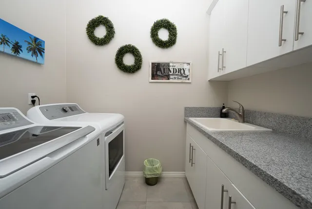 a utility room with a sink and a stove