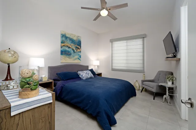 a living room with a bed furniture and a window