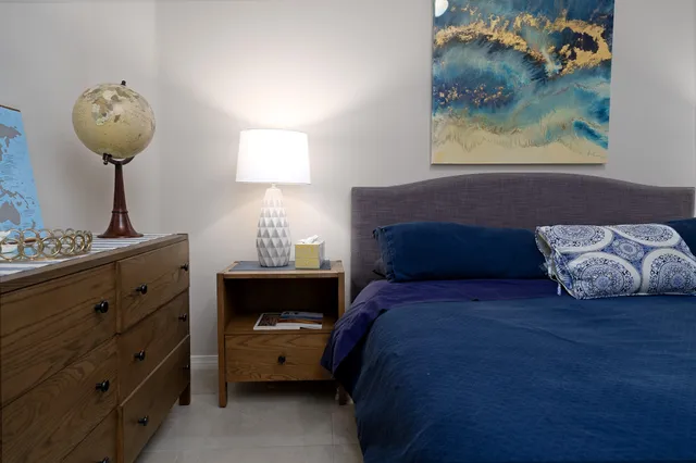 a bedroom with a bed and window