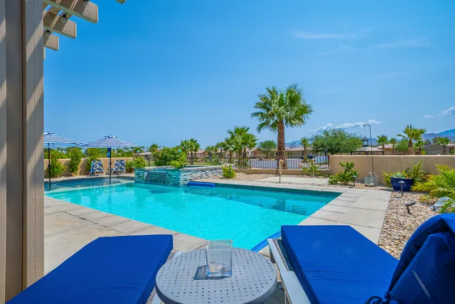 a view of a swimming pool with an outdoor seating