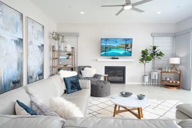 a living room with furniture a fireplace and a flat screen tv