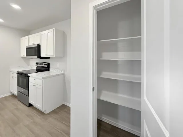 a view of hallway with wooden floor