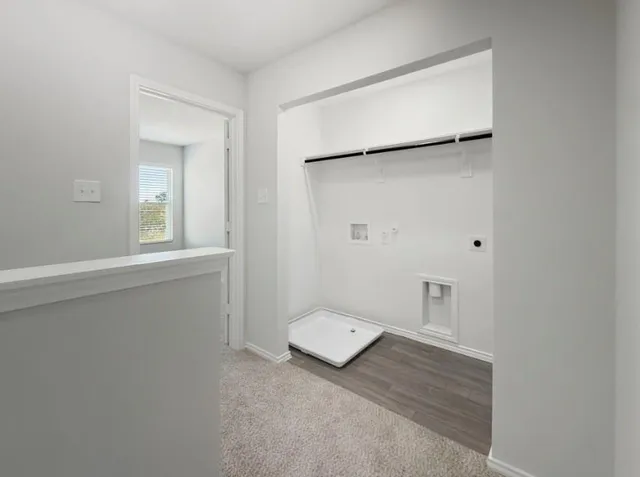 a view of a hallway with white walls