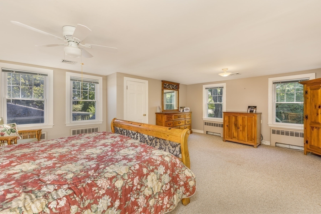 27 Preston Beach Road Marblehead, MA 01945 - Photo 23 of 32 a spacious bedroom with a bed and glass door