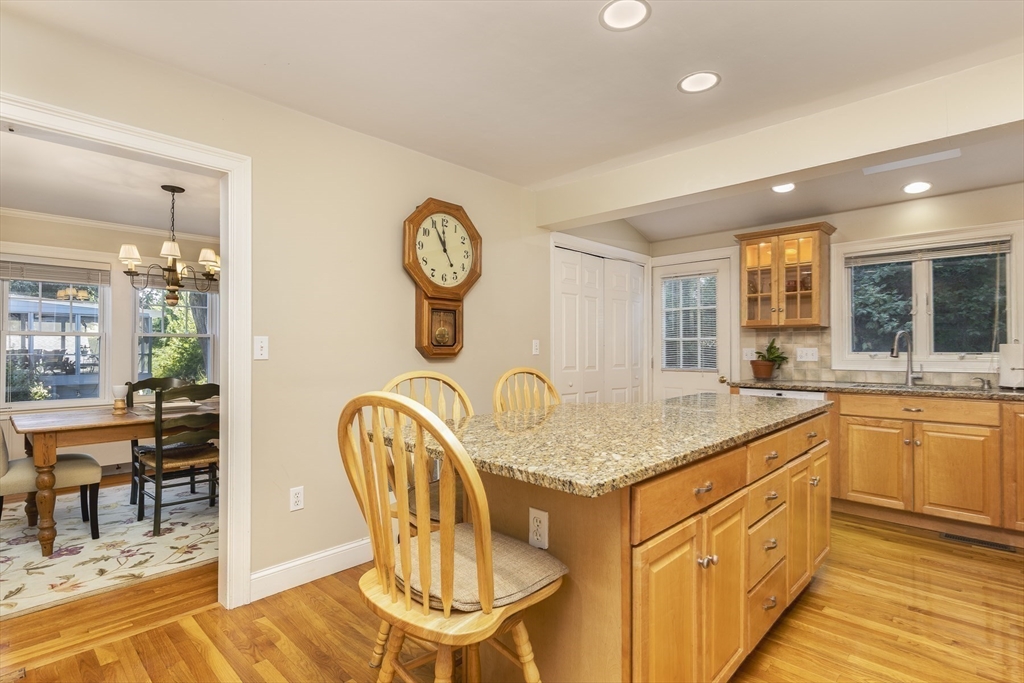 27 Preston Beach Road Marblehead, MA 01945 - Photo 10 of 32 a kitchen with stainless steel appliances granite countertop a table chairs and a wooden floor