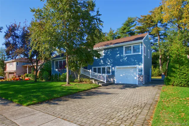 a view of a house with a yard porch and sitting area