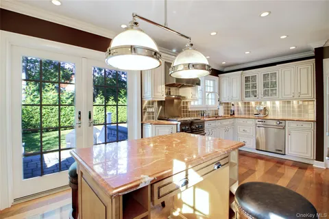 a kitchen with stainless steel appliances granite countertop a sink a stove and a refrigerator