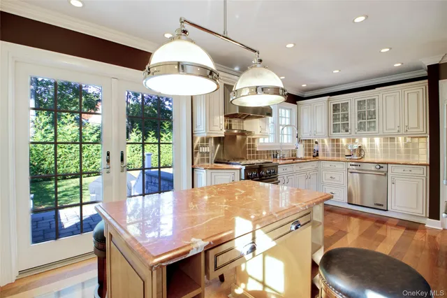 a kitchen with stainless steel appliances granite countertop a sink a stove and a refrigerator