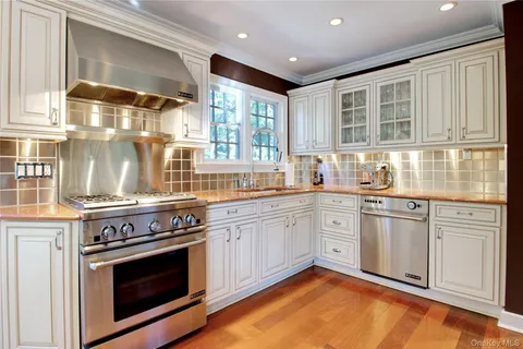 a kitchen with stainless steel appliances granite countertop a stove and cabinets