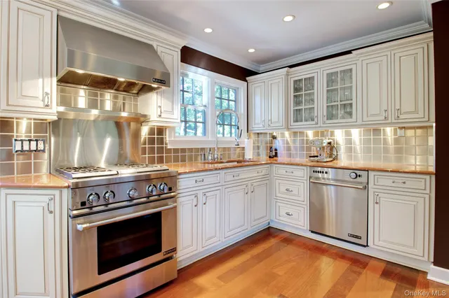 a kitchen with stainless steel appliances granite countertop a stove and cabinets