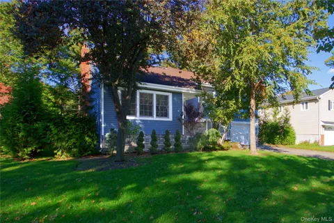 a view of house with backyard
