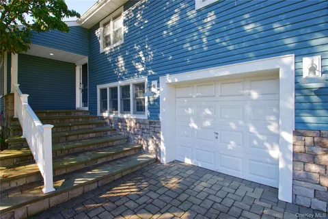 a view of a porch with wooden chairs