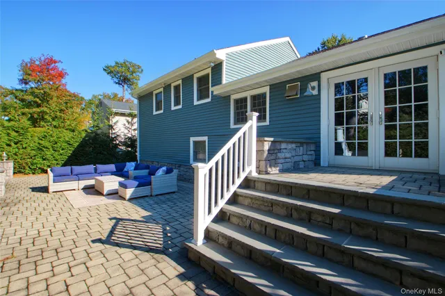 a view of a house with backyard and sitting area