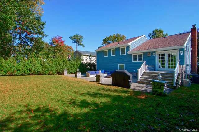 a view of a house with backyard porch and sitting area