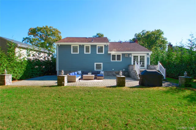 a front view of a house with a yard and trees