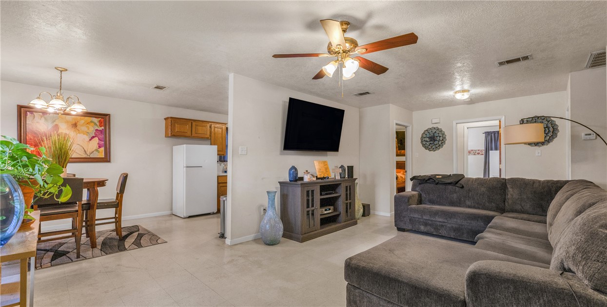 1009 West 17th Street Bryan, TX 77803 - Photo 2 of 11 a living room with furniture and a flat screen tv