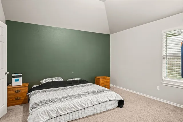 a bedroom with a bed and window