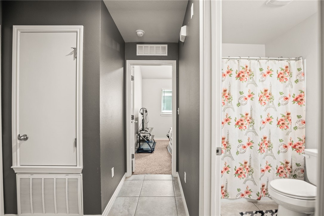 6718 Breeann Street Corpus Christi, TX 78413 - Photo 14 of 22 a bathroom with a shower and a toilet