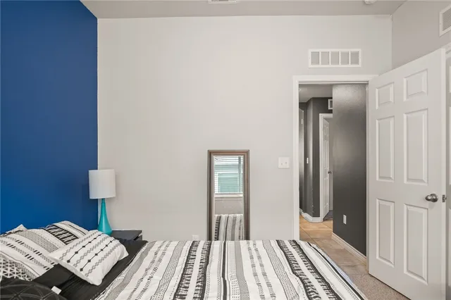 a view of a bedroom with wooden floor and bed