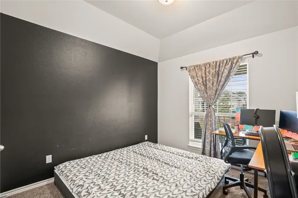 a bedroom with a bed and a table in it