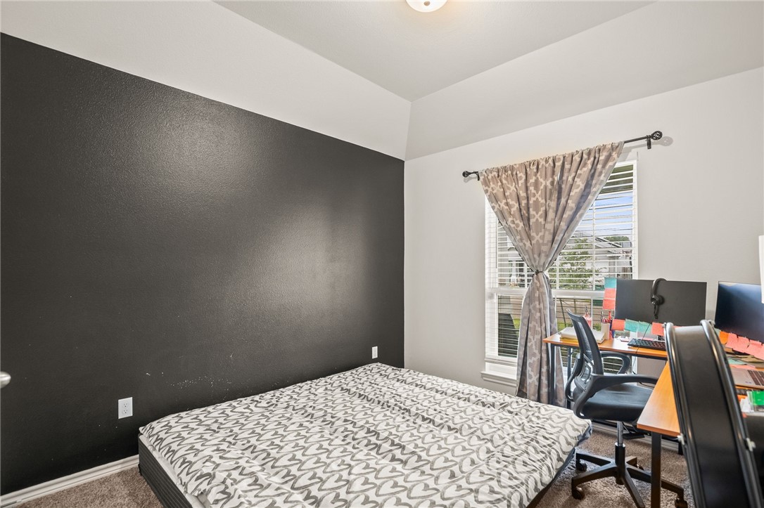 6718 Breeann Street Corpus Christi, TX 78413 - Photo 18 of 22 a bedroom with a bed and a table in it