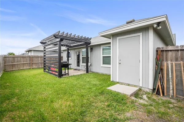 a view of a house with backyard and porch