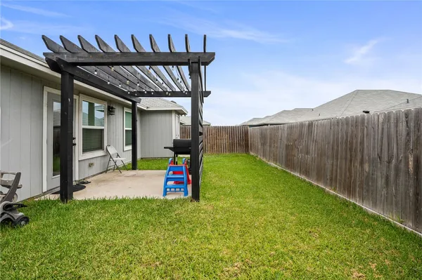 a view of a backyard with a patio and a garden