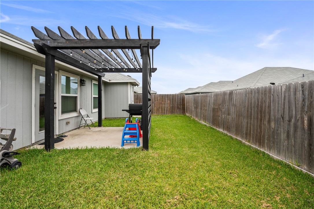 6718 Breeann Street Corpus Christi, TX 78413 - Photo 22 of 22 a view of a backyard with a patio and a garden