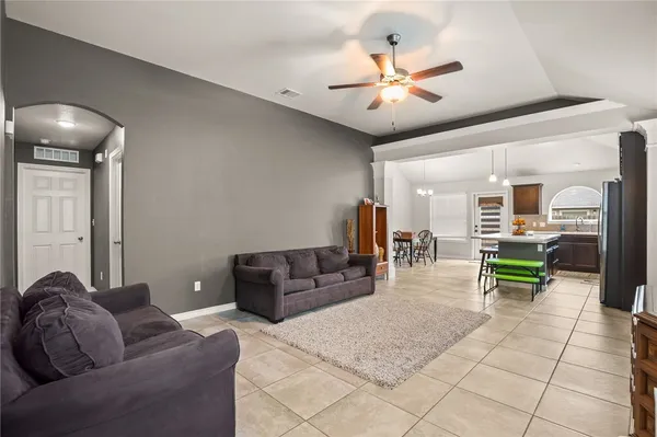 a living room with furniture and a chandelier