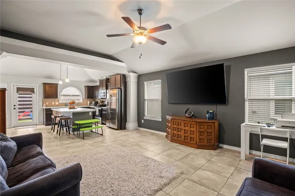 a living room with furniture and a flat screen tv