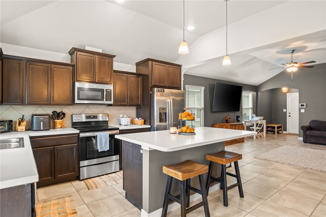 6718 Breeann Street Corpus Christi, TX 78413 - Photo 8 of 22 a open kitchen with stainless steel appliances granite countertop a sink dishwasher a dining table and chairs with wooden floor