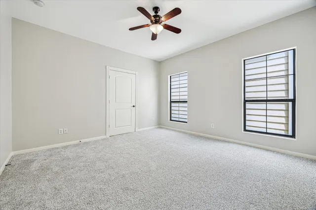 a view of a livingroom with a ceiling fan and window