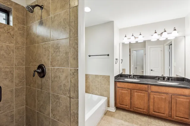 a bathroom with a granite countertop sink a mirror and shower