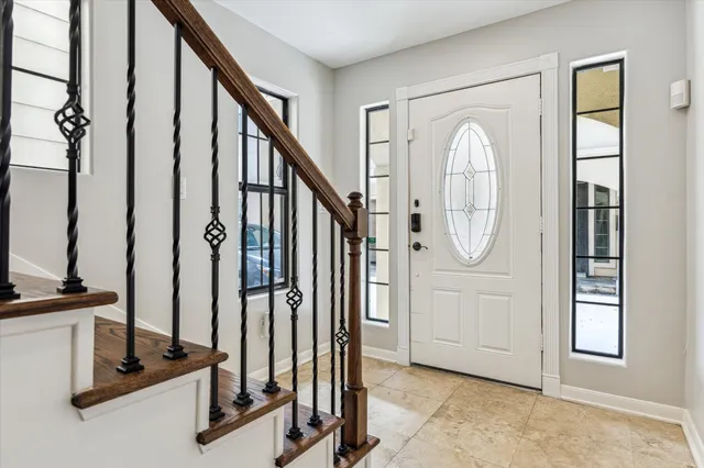 a view of a livingroom with hardwood floor and staircase