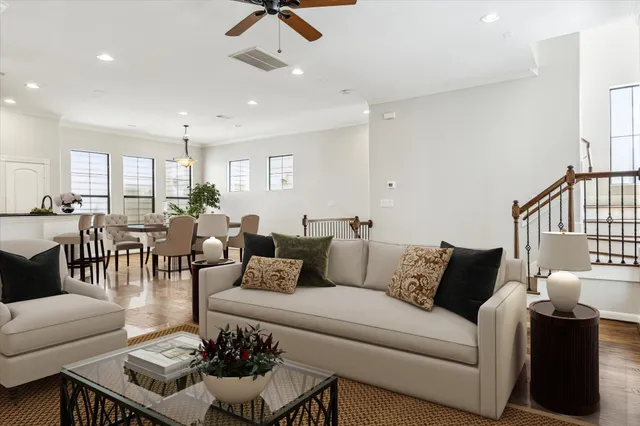 a living room with furniture and a chandelier