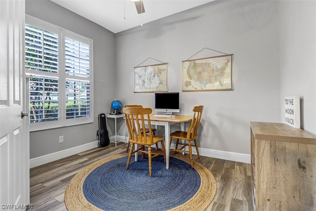 3944 Ruxton Road Naples, FL 34116 - Photo 13 of 23 a dining room with furniture and wooden floor