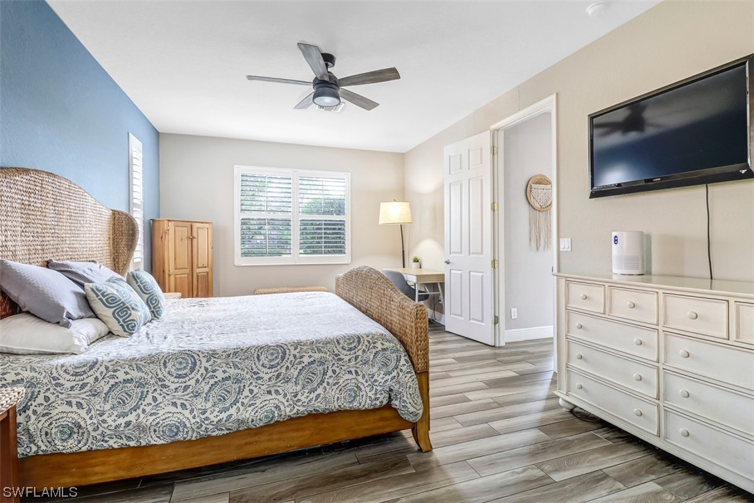 3944 Ruxton Road Naples, FL 34116 - Photo 14 of 23 a bedroom with a large bed and a flat tv screen on dresser