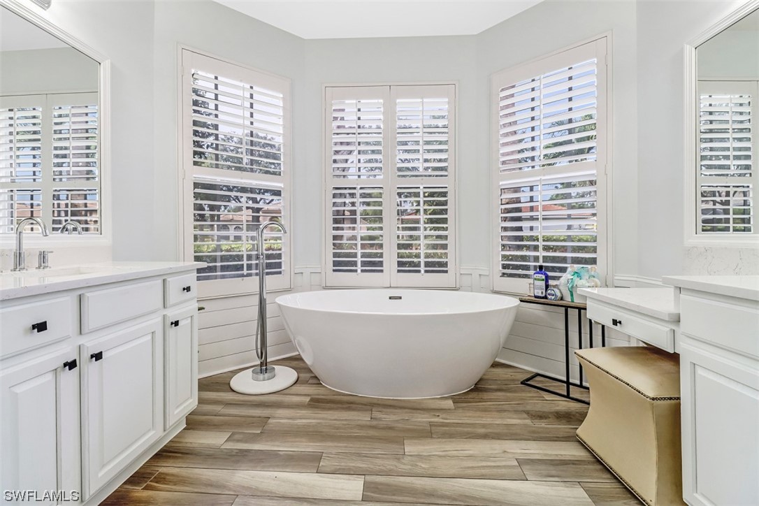 3944 Ruxton Road Naples, FL 34116 - Photo 18 of 23 a spacious bathroom with a bathtub and a window
