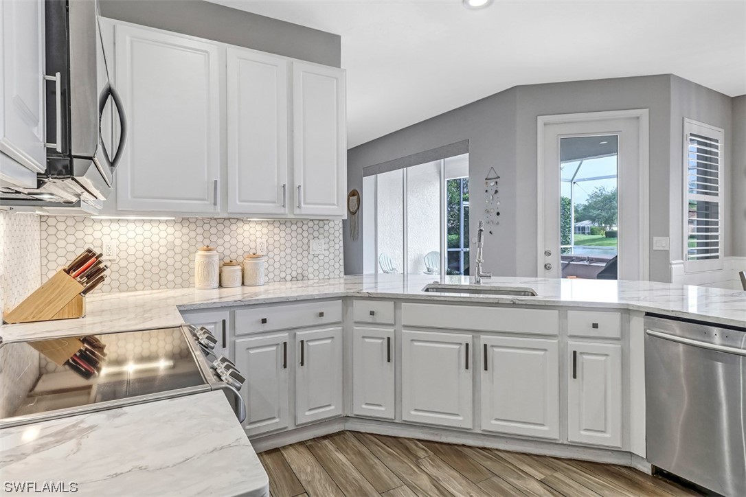 3944 Ruxton Road Naples, FL 34116 - Photo 2 of 23 a kitchen with white cabinets and sink