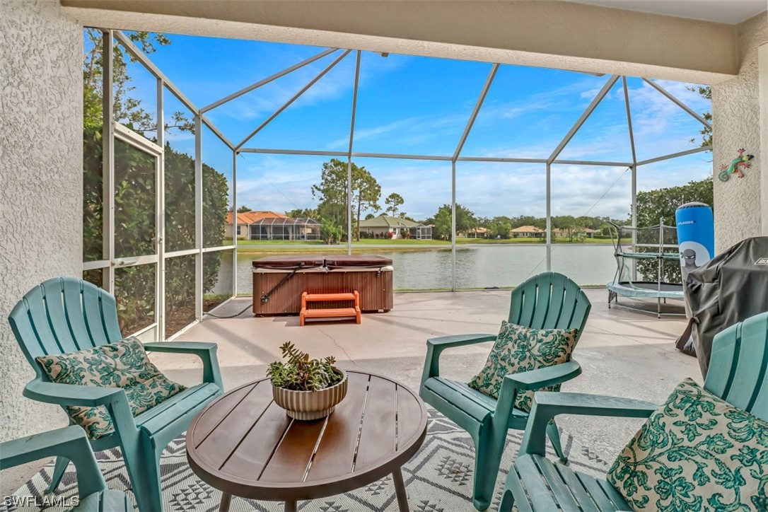 3944 Ruxton Road Naples, FL 34116 - Photo 23 of 23 a outdoor living space with furniture and umbrella