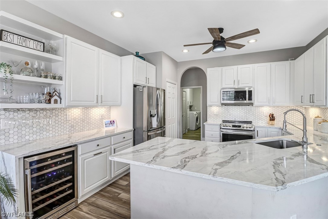 3944 Ruxton Road Naples, FL 34116 - Photo 3 of 23 a kitchen with stainless steel appliances a stove cabinets and a refrigerator