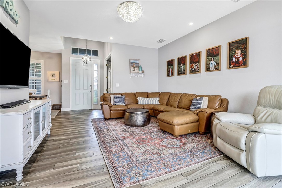 3944 Ruxton Road Naples, FL 34116 - Photo 7 of 23 a living room with furniture and a flat screen tv