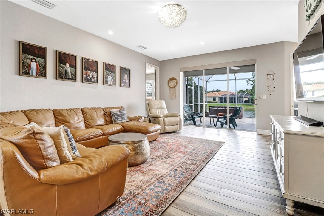 3944 Ruxton Road Naples, FL 34116 - Photo 8 of 23 a living room with furniture wooden floor and windows
